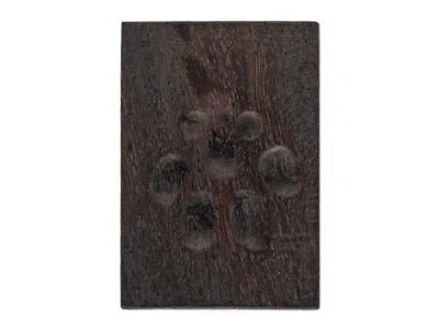 Small hand carved abstract wooden sculpture of paw print
